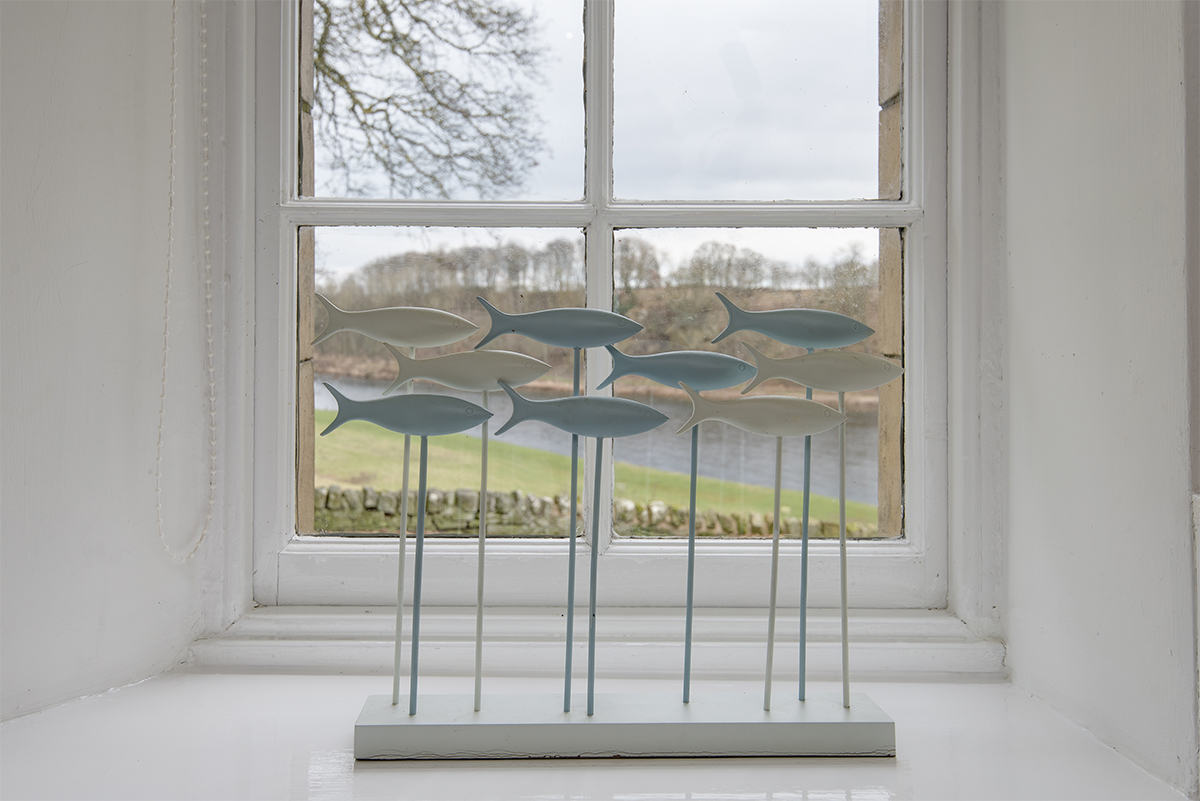 https://talesofthetweed.co.uk/wp-content/uploads/2019/06/Milne-Graden-Tweedside-Holiday-Cottage-Bathroom-View-to-River-Tweed-with -swimming-fish-sculpture-on-windowsill
