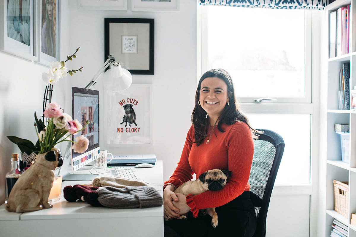 Milne-Graden-Press-Rosie-Sugden-Cashmere-Rosie-sitting-at-her-desk-with-pug-dog