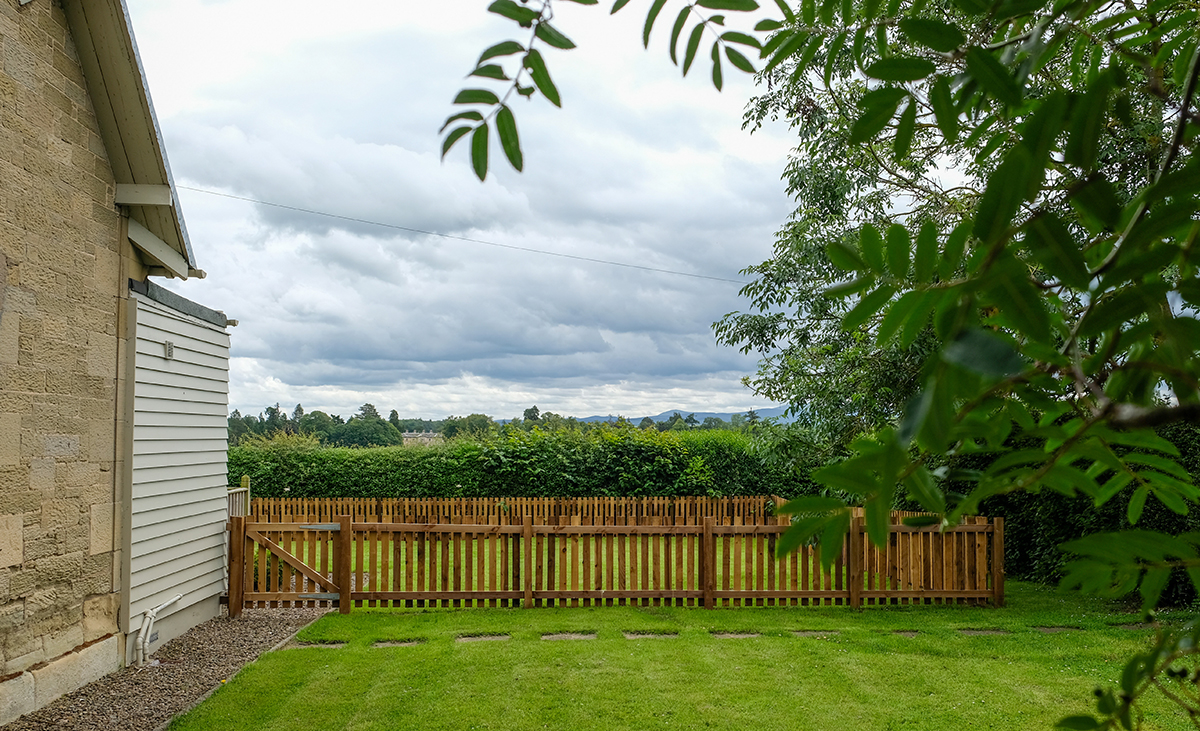 Looking-through-trees-at-North-Lodge-Holiday-Cottage-Enclosed-Dog-Friendly-Garden